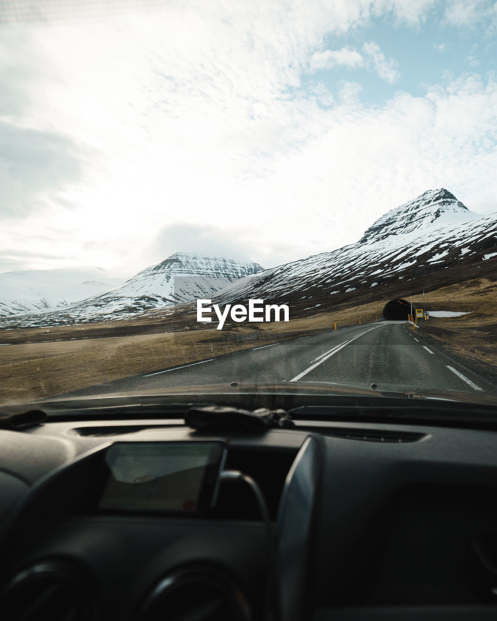 Road against sky seen through car windshield