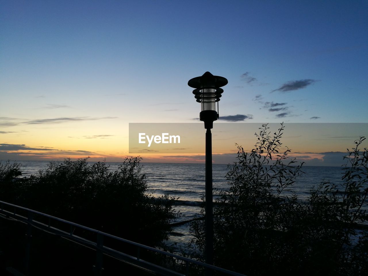 Silhouette street light against sky during sunset