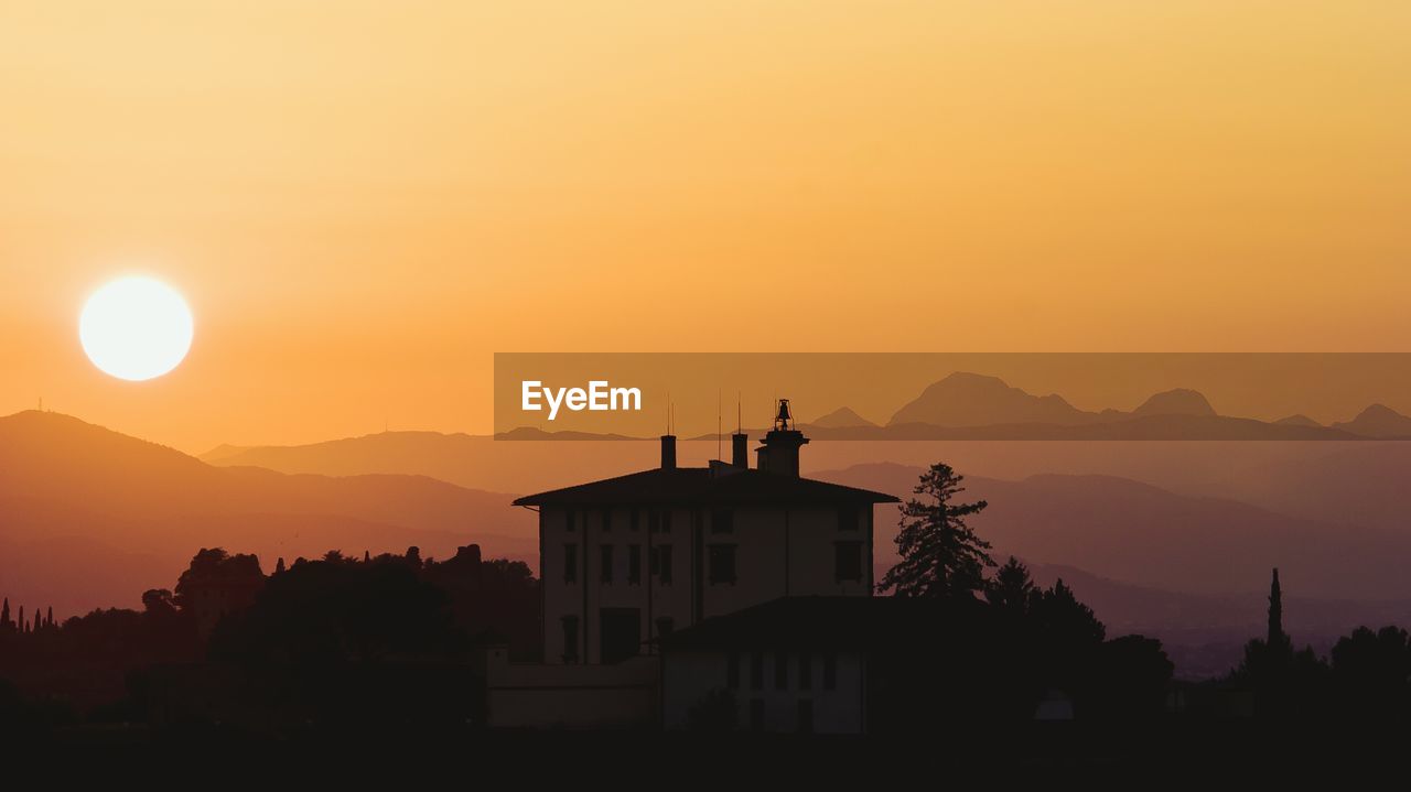 Silhouette building against sky during sunset