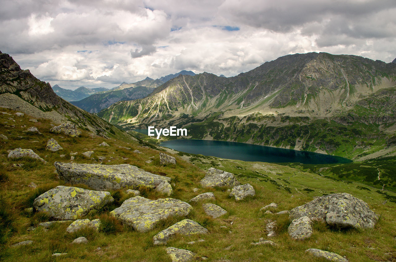 Scenic view of lake and mountains against sky