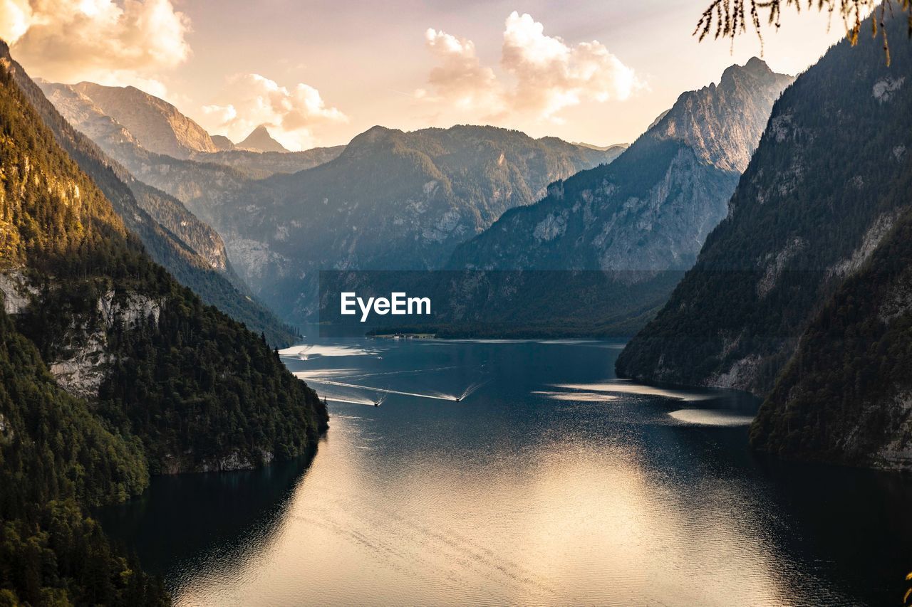 Scenic view of river amidst mountains against sky