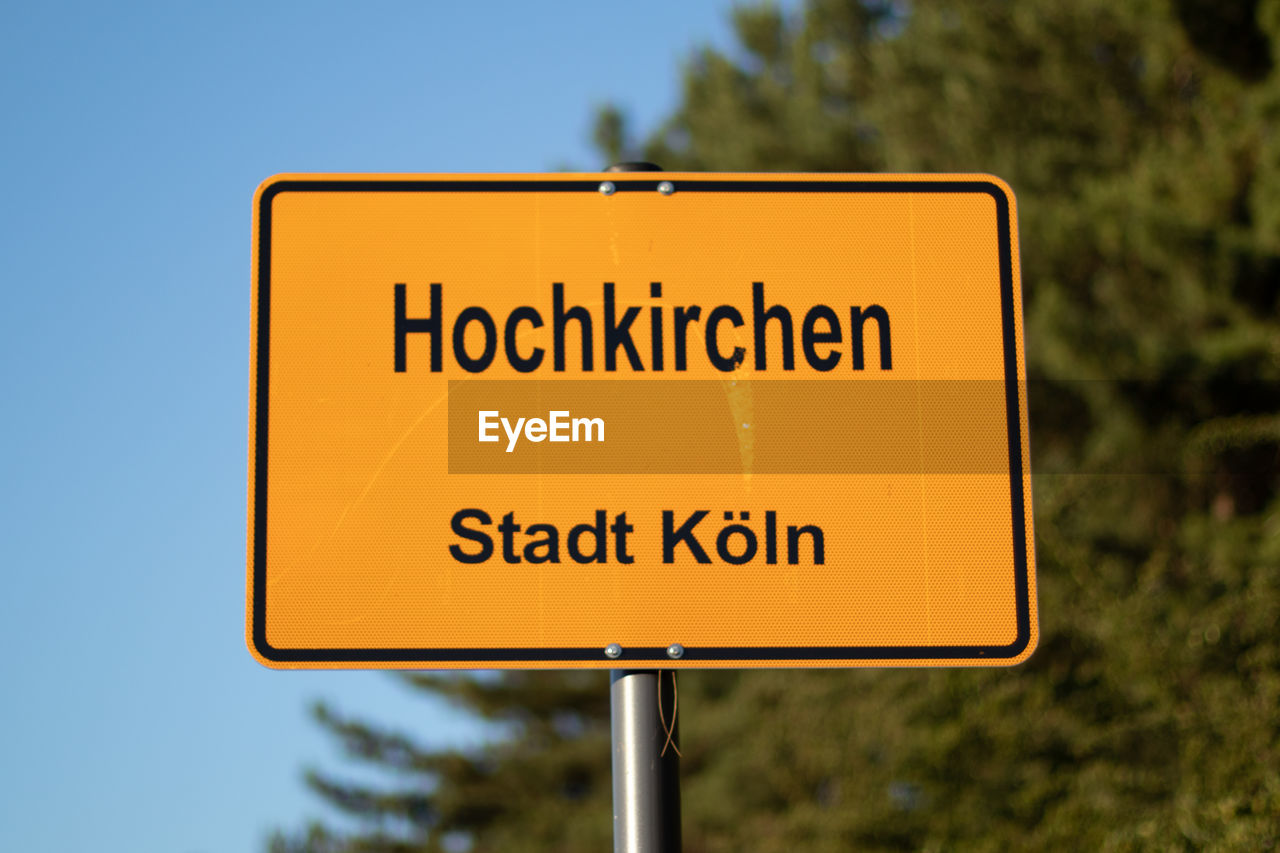 CLOSE-UP OF SIGN ON ROAD
