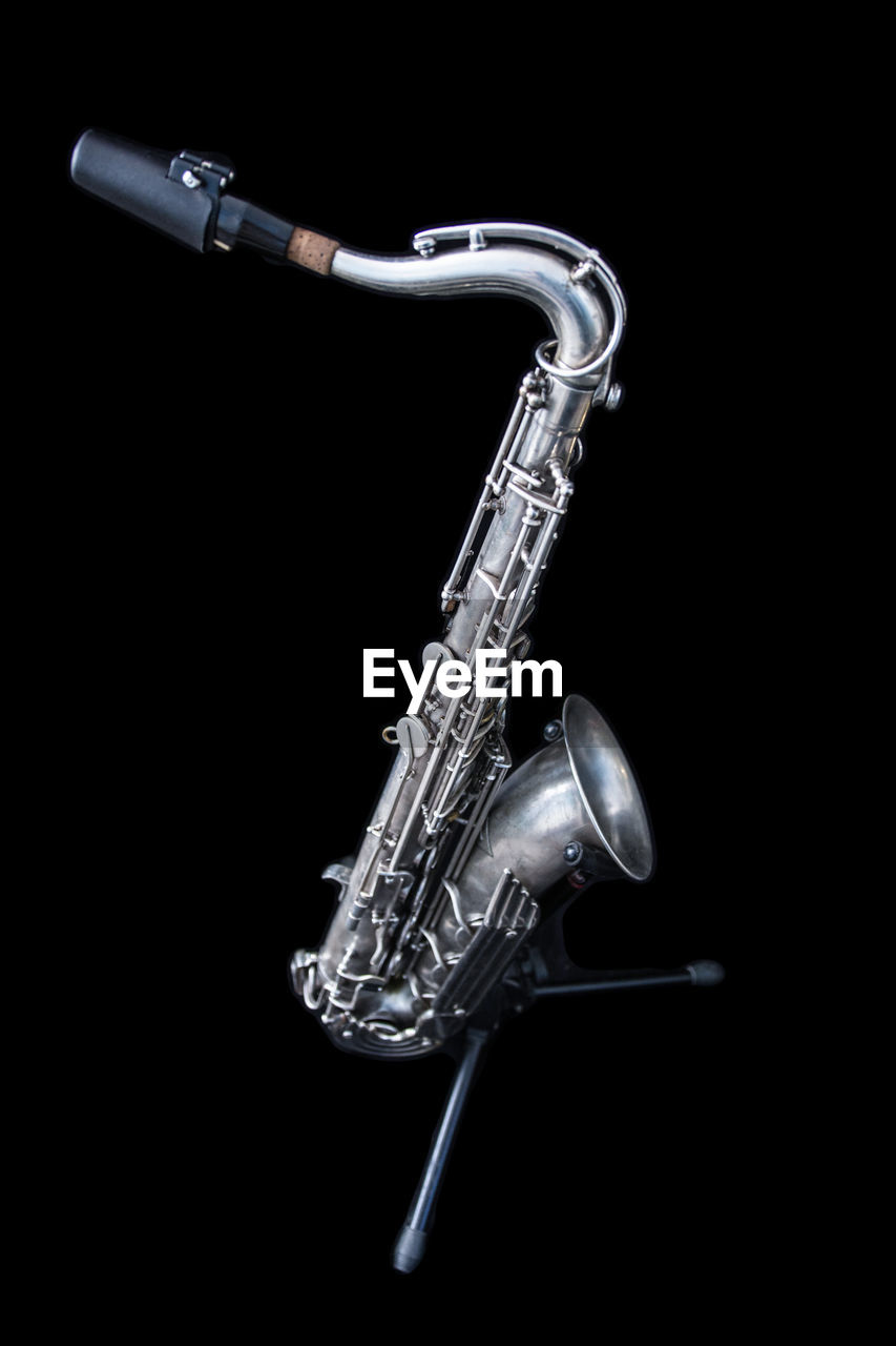 Saxophone against black background
