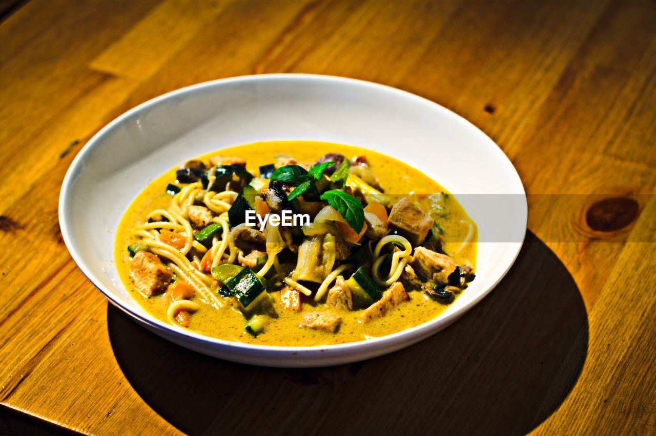 High angle view of curry soup in bowl on table