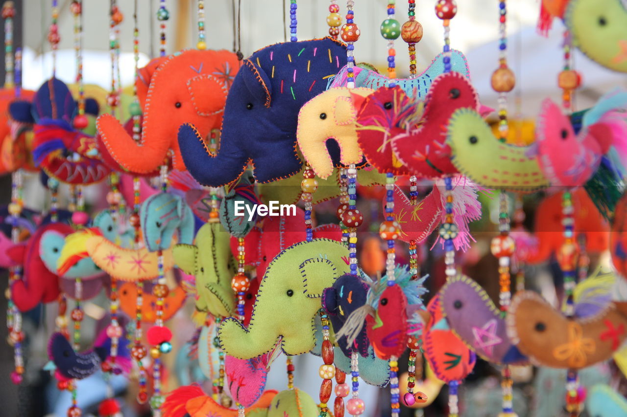 Close-up of toys hanging at market stall