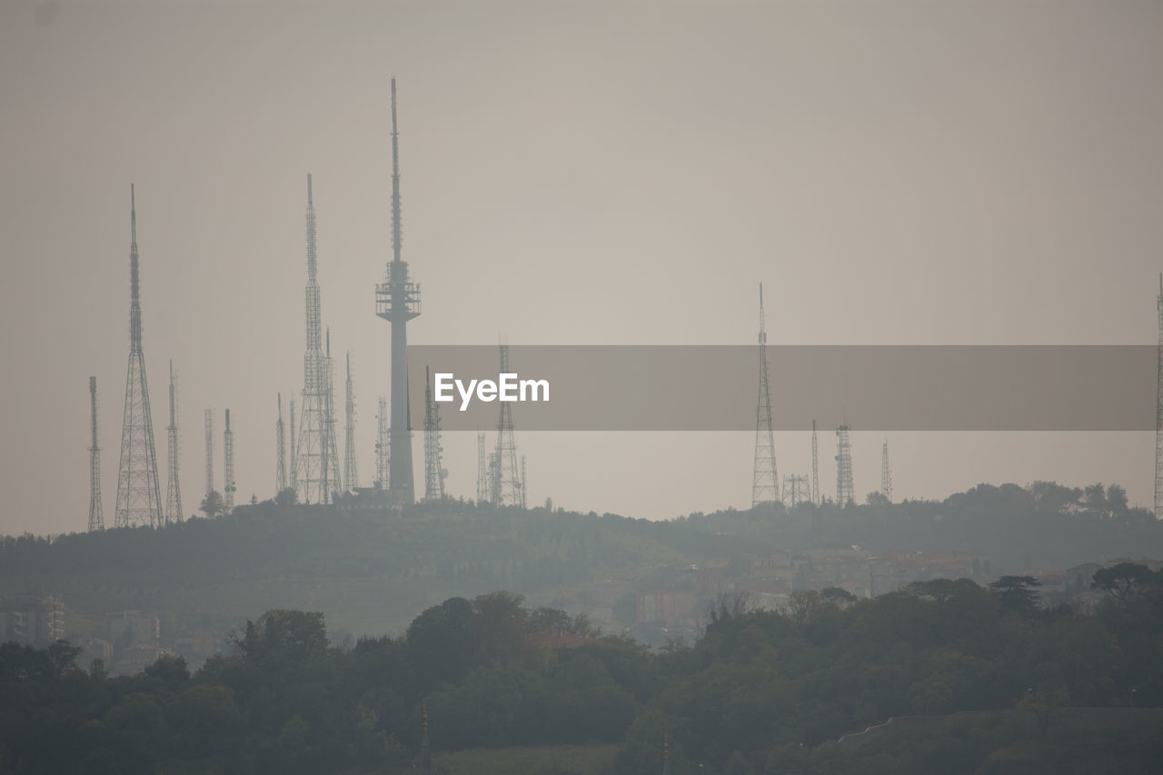 Communications tower and electricity pylons