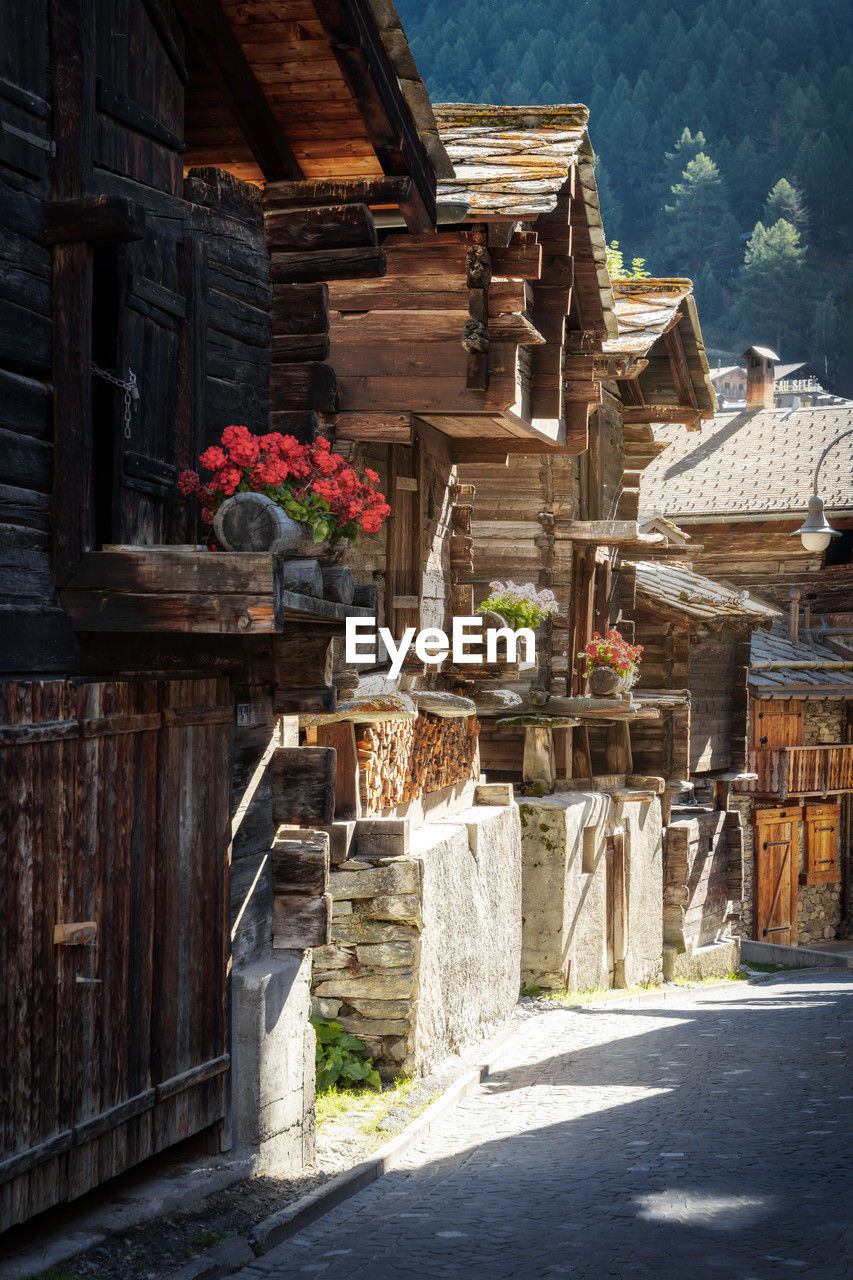 architecture, town, built structure, building exterior, building, nature, plant, flower, house, village, flowering plant, no people, city, temple, sunlight, wood, travel destinations, day, road, history, outdoors, alley, urban area, tradition, street, the past, residential district, travel, ancient history, wall, religion, old, tourism