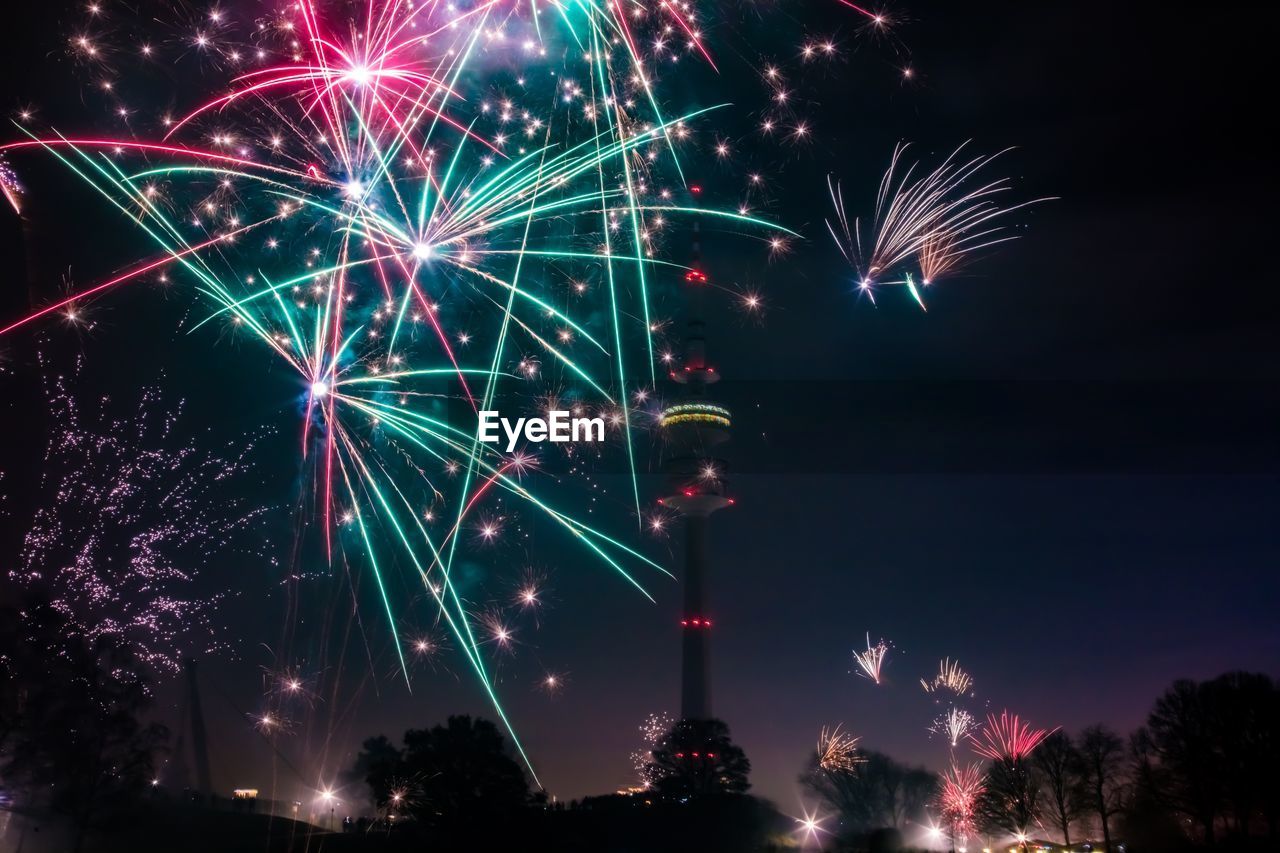 Low angle view of firework display at night