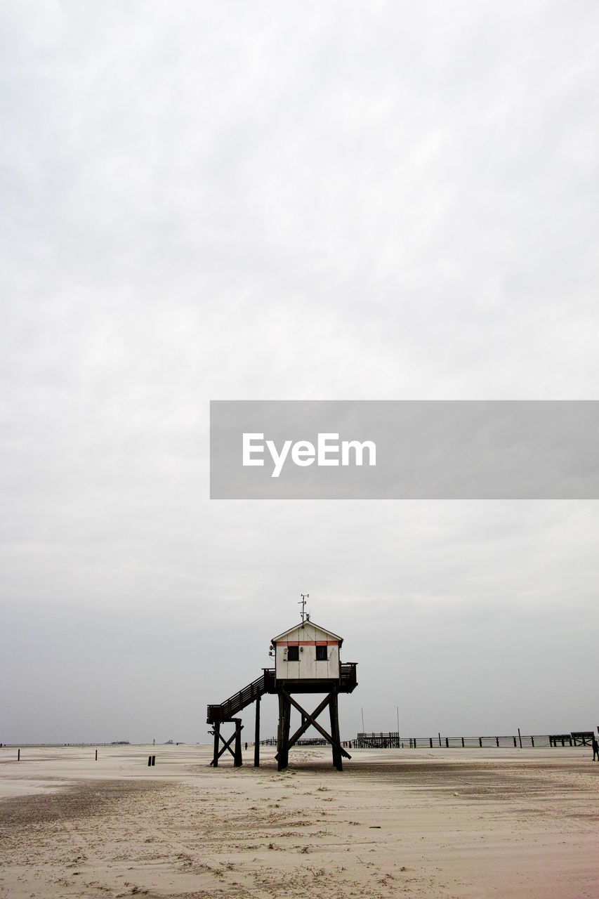 Lifeguard hut on beach against sky