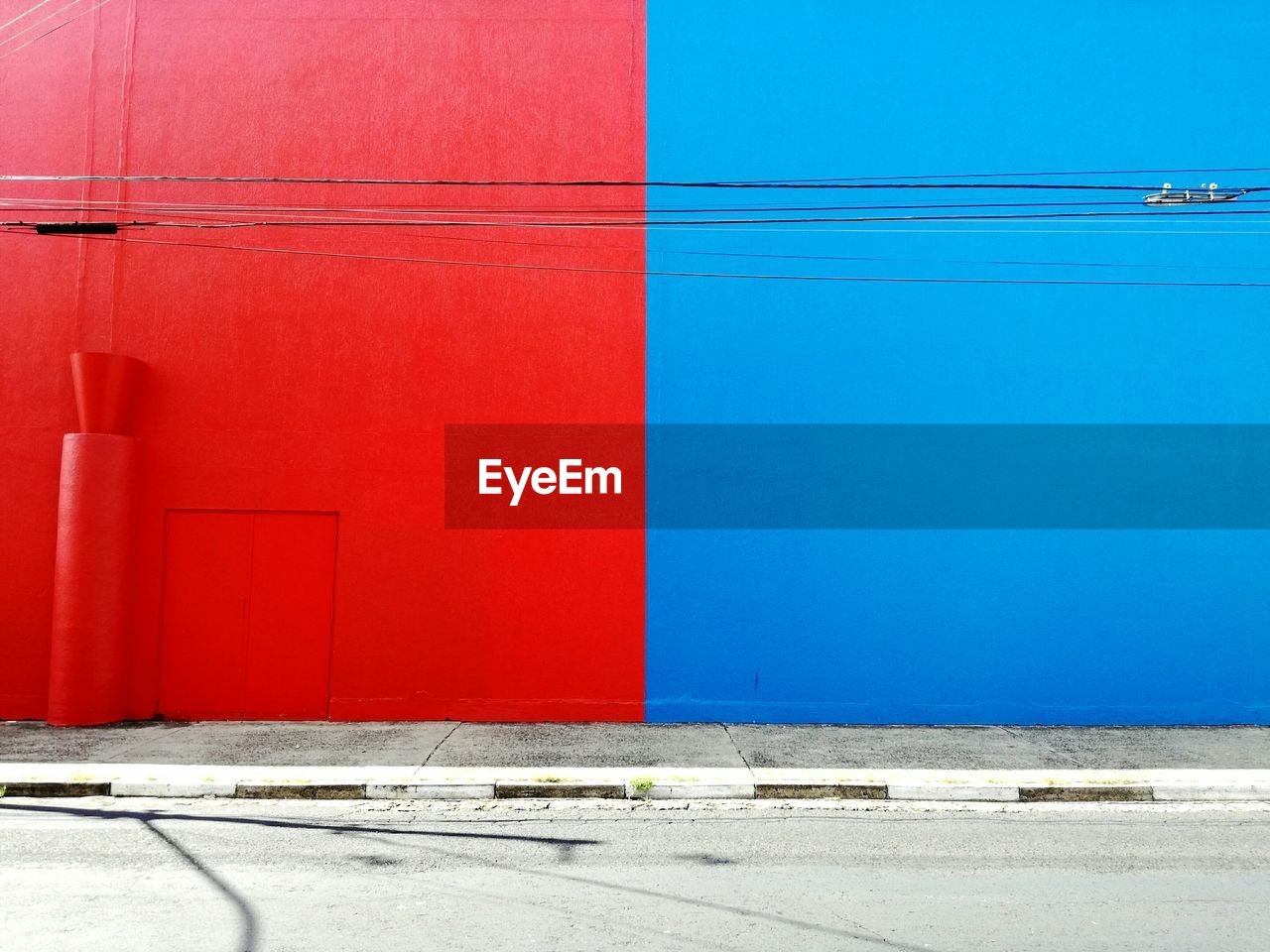 Red and blue wall by street