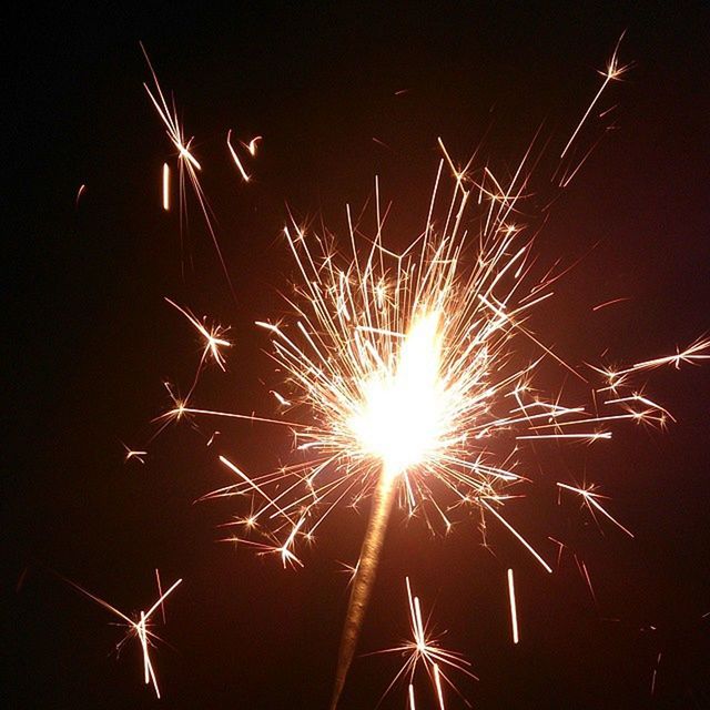 LOW ANGLE VIEW OF ILLUMINATED FIREWORKS