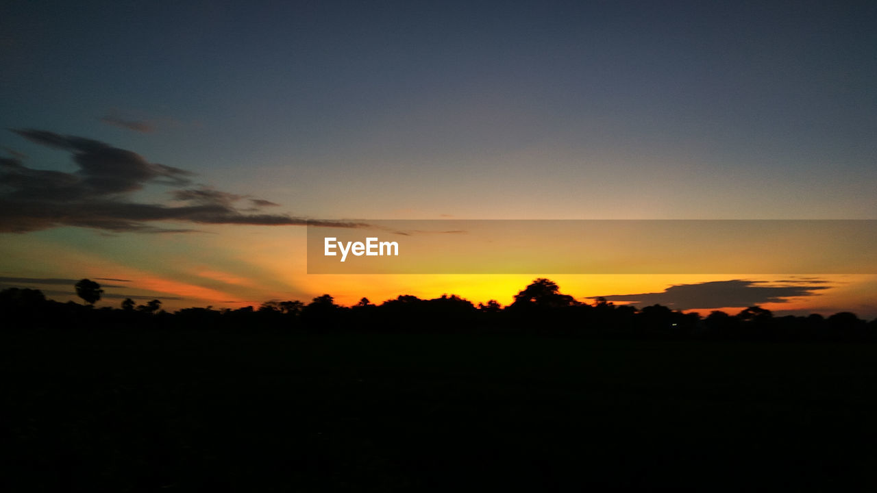 SCENIC VIEW OF SILHOUETTE LANDSCAPE AGAINST DRAMATIC SKY