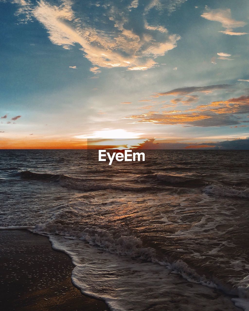 Scenic view of beach against sky during sunset