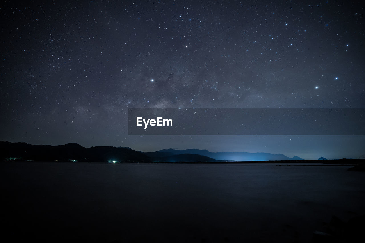 Scenic view of lake against star field at night