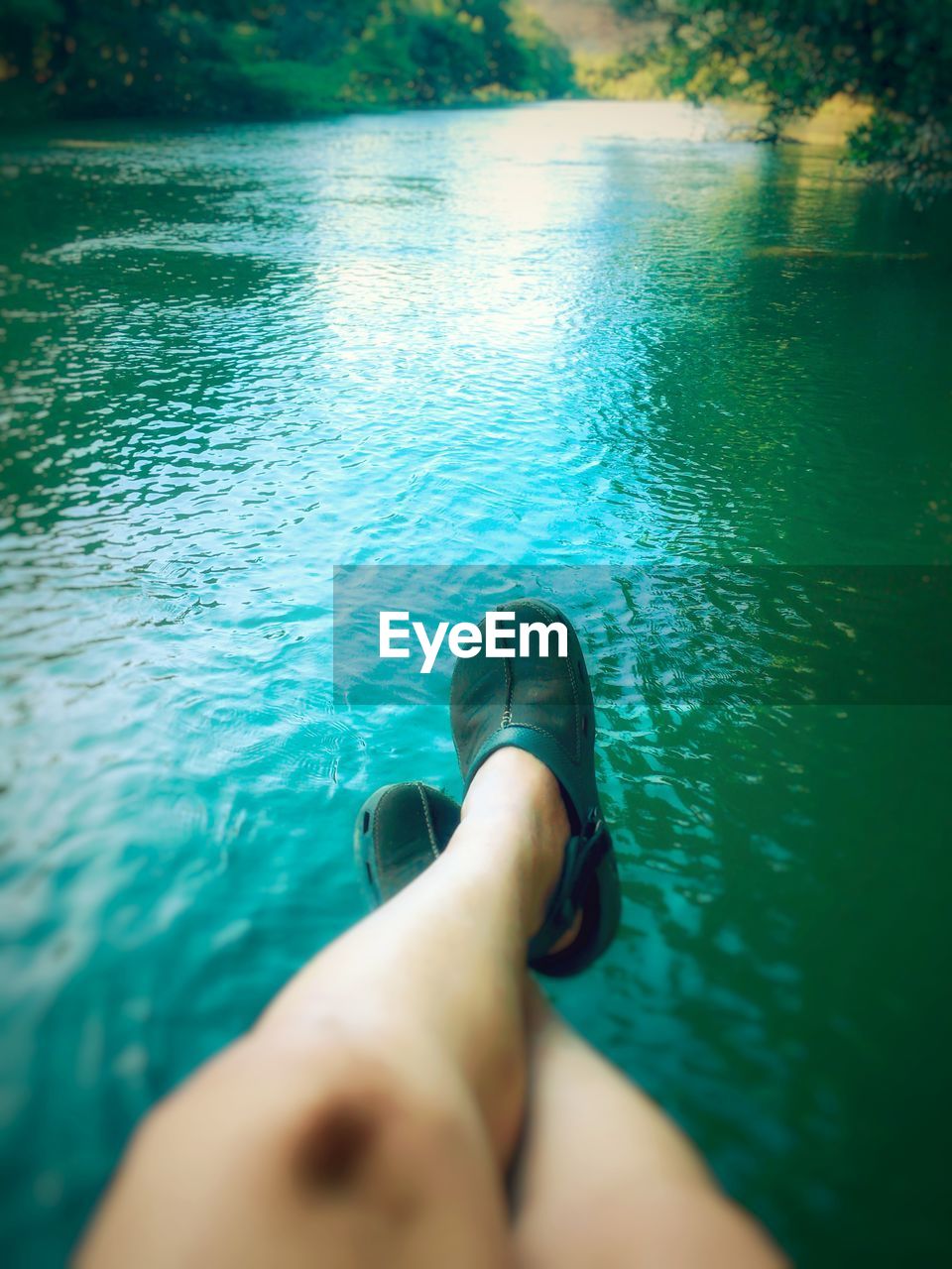 Low section of woman relaxing in lake