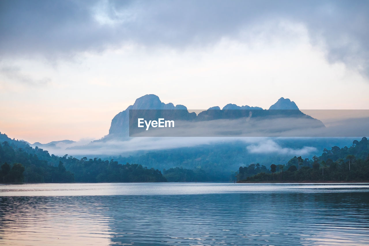 Scenic view of lake and mountains against sky