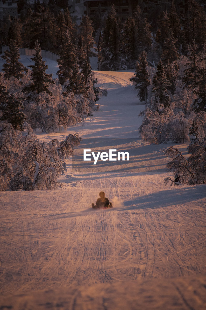 Scenic view of person sliding down slope