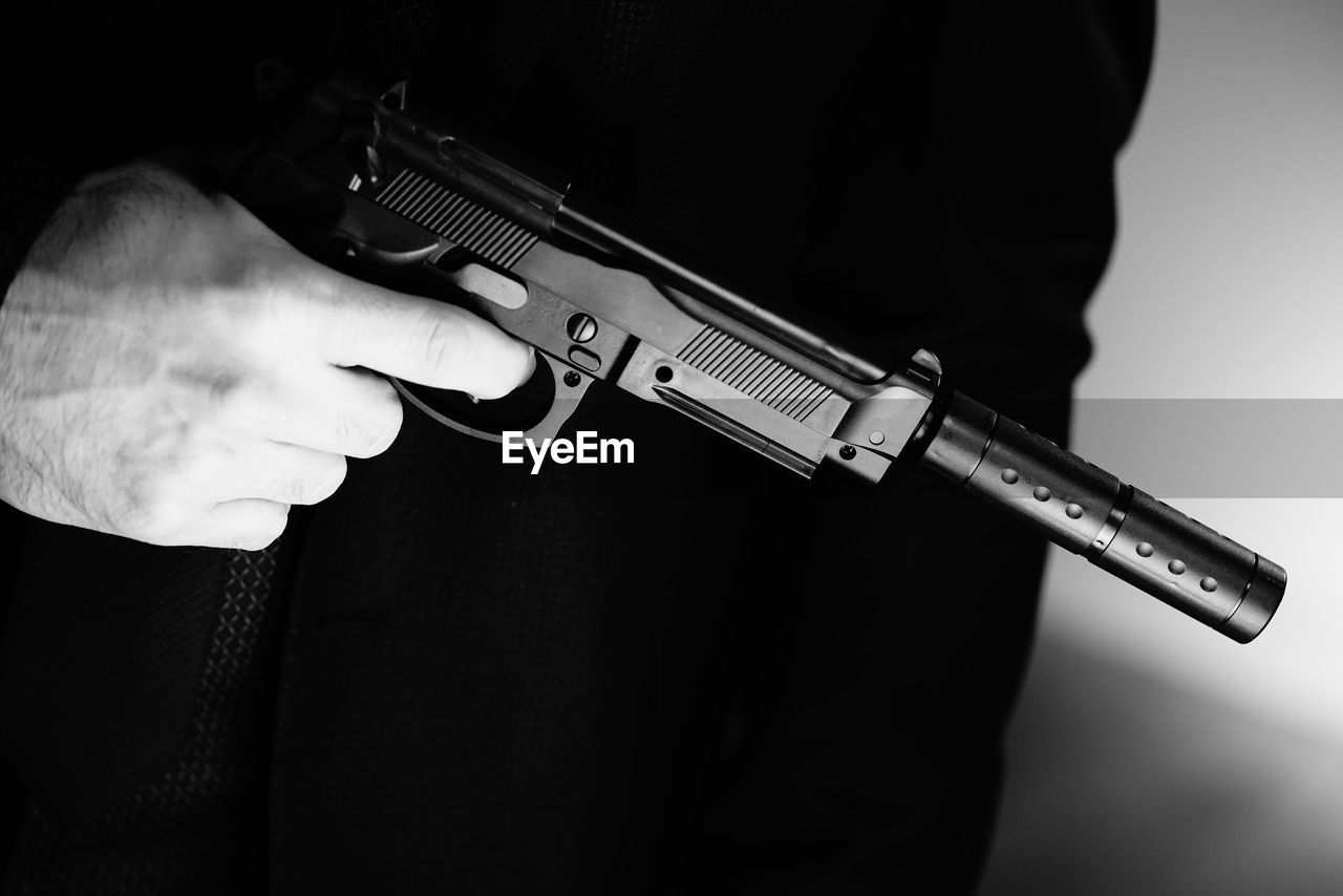 black, gun, weapon, handgun, firearm, black and white, hand, aggression, one person, violence, gun barrel, monochrome, warning sign, holding, monochrome photography, social issues, crime, sign, adult, studio shot, indoors, security, men, assault rifle