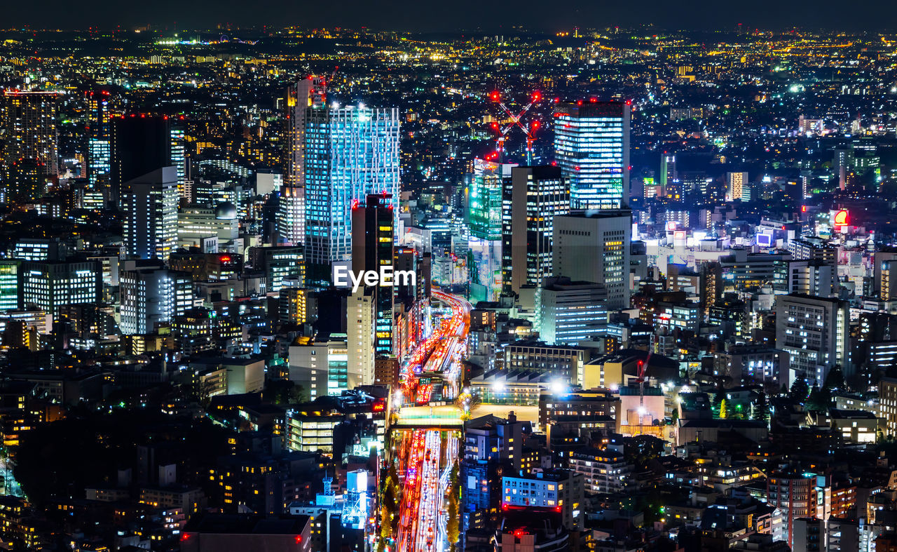 High angle view of illuminated buildings in city at night