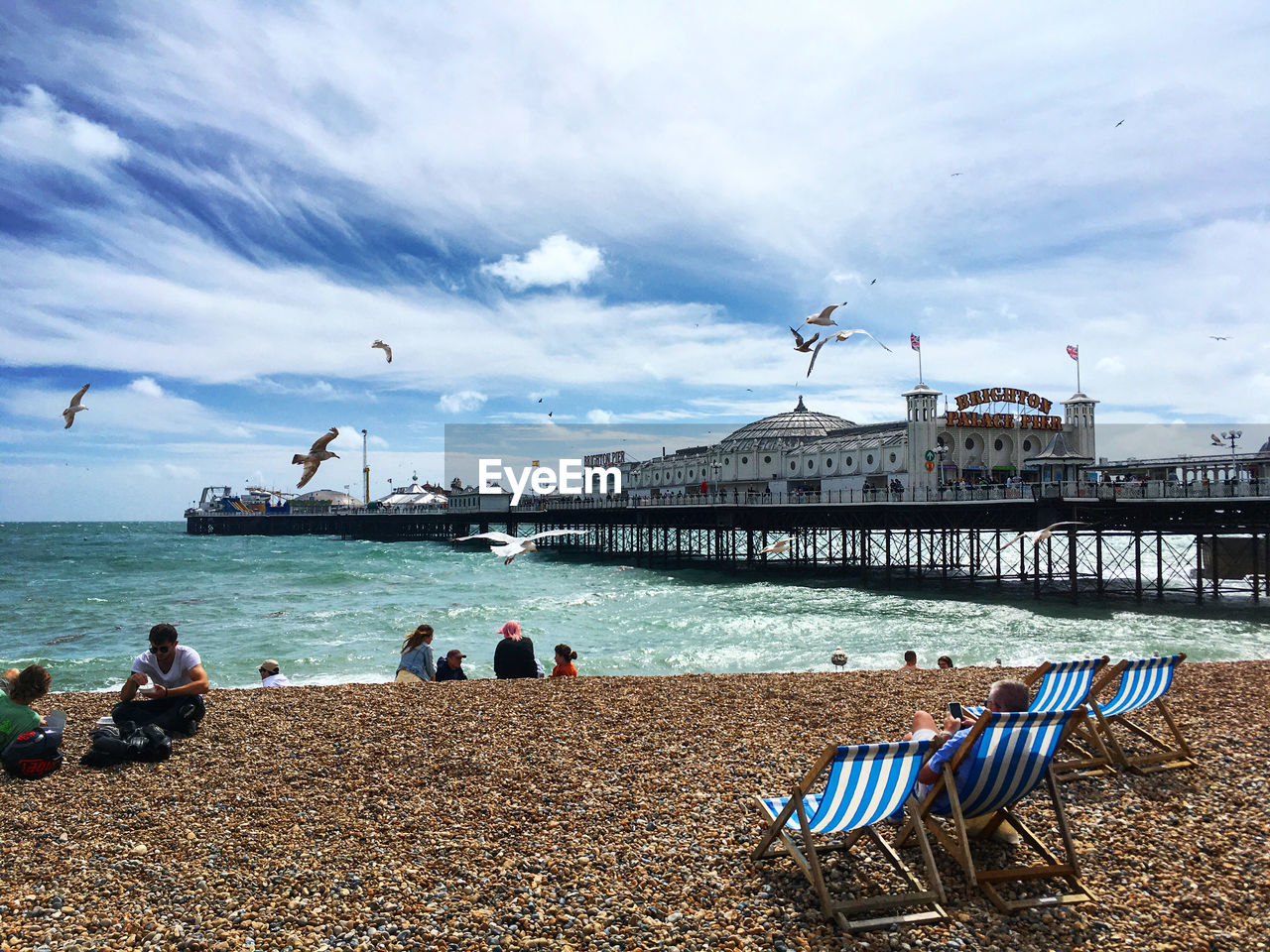 PEOPLE SITTING ON BEACH