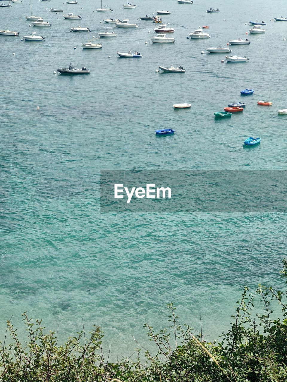 water, nautical vessel, sea, transportation, shore, mode of transportation, nature, coast, day, high angle view, ship, no people, beauty in nature, bay, scenics - nature, body of water, ocean, tranquility, land, outdoors, blue, beach, vehicle, travel, tranquil scene, sailboat, moored, plant, travel destinations, idyllic, harbor