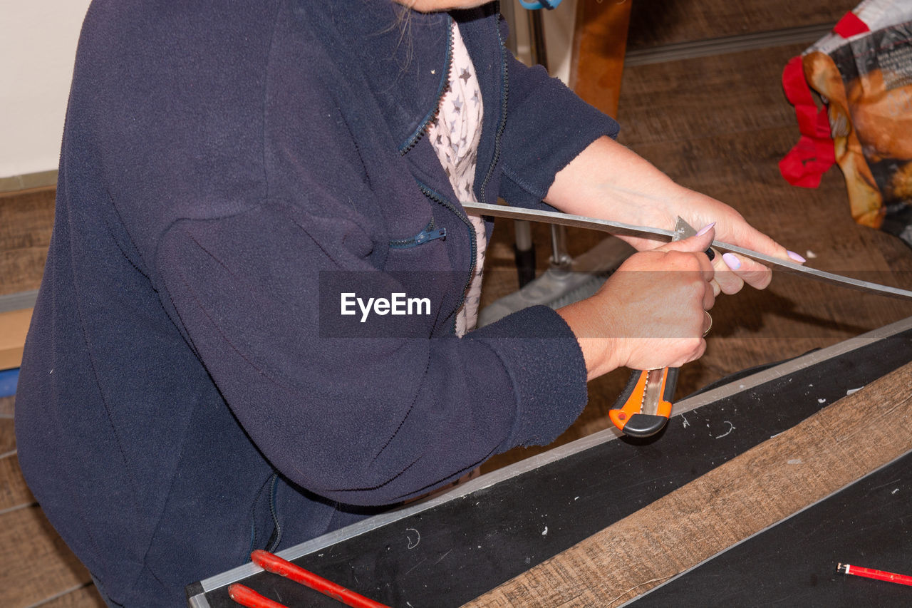 Midsection of worker working at shop