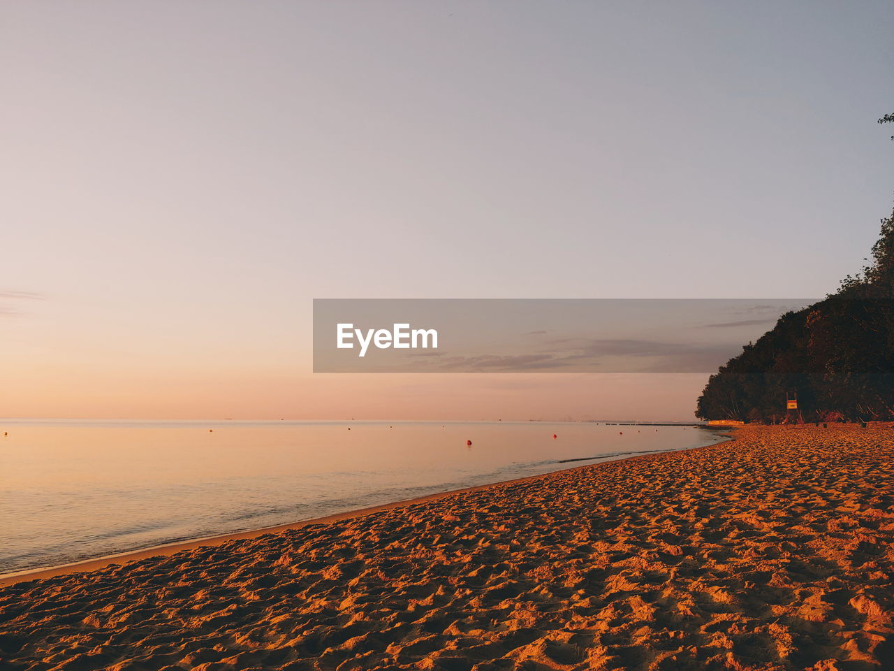 Scenic view of beach against sky during sunset