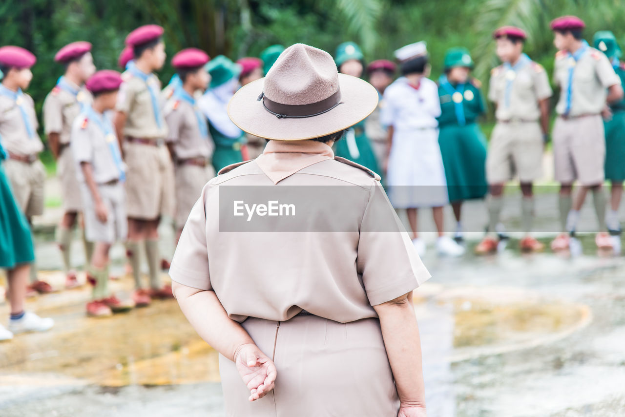 Children wearing uniforms standing outdoors