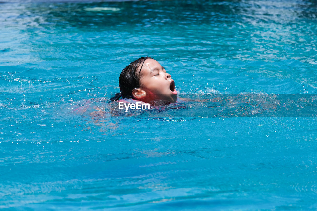 high angle view of woman swimming in pool