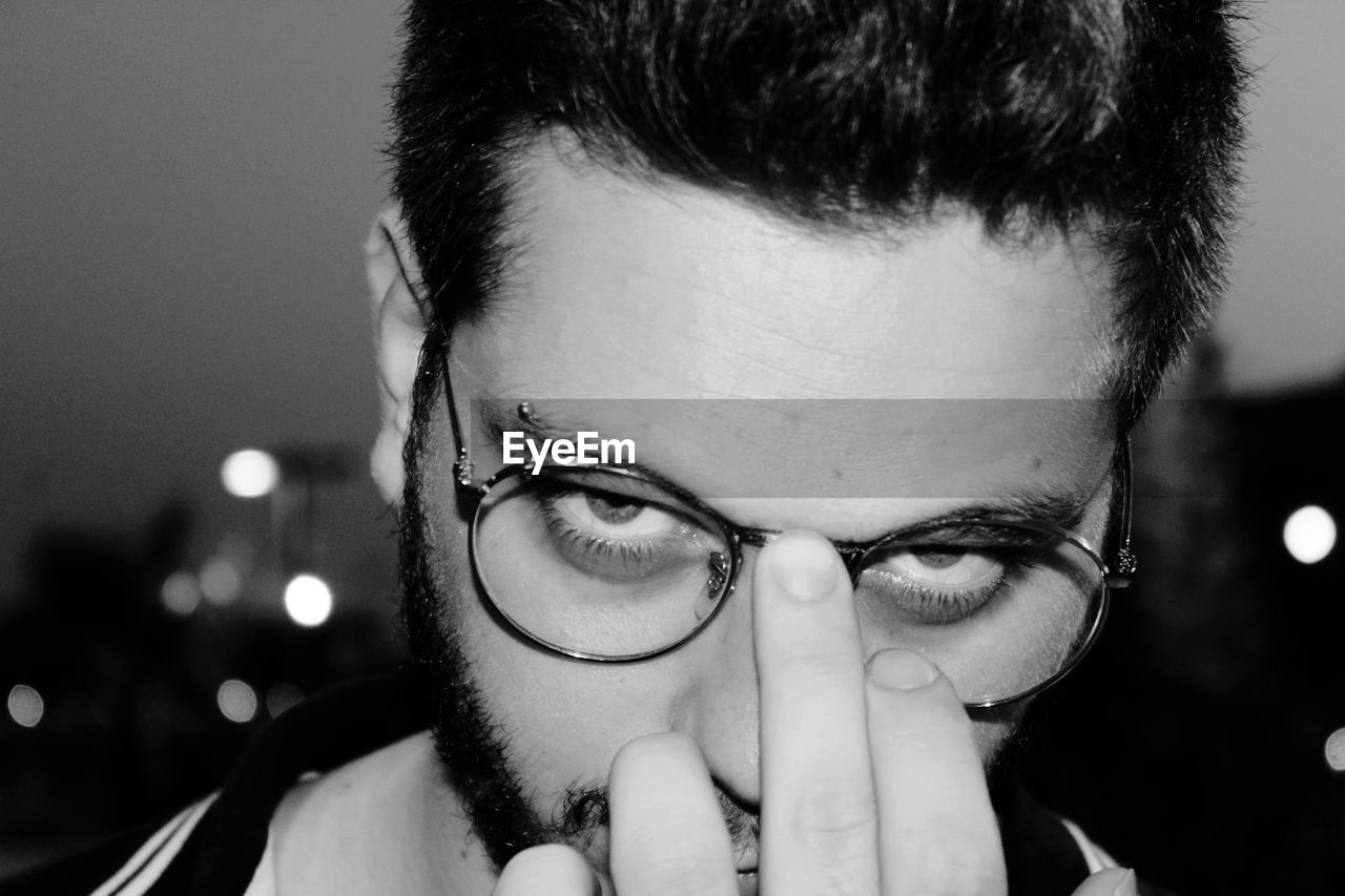 Close-up of young man wearing eyeglasses bnw