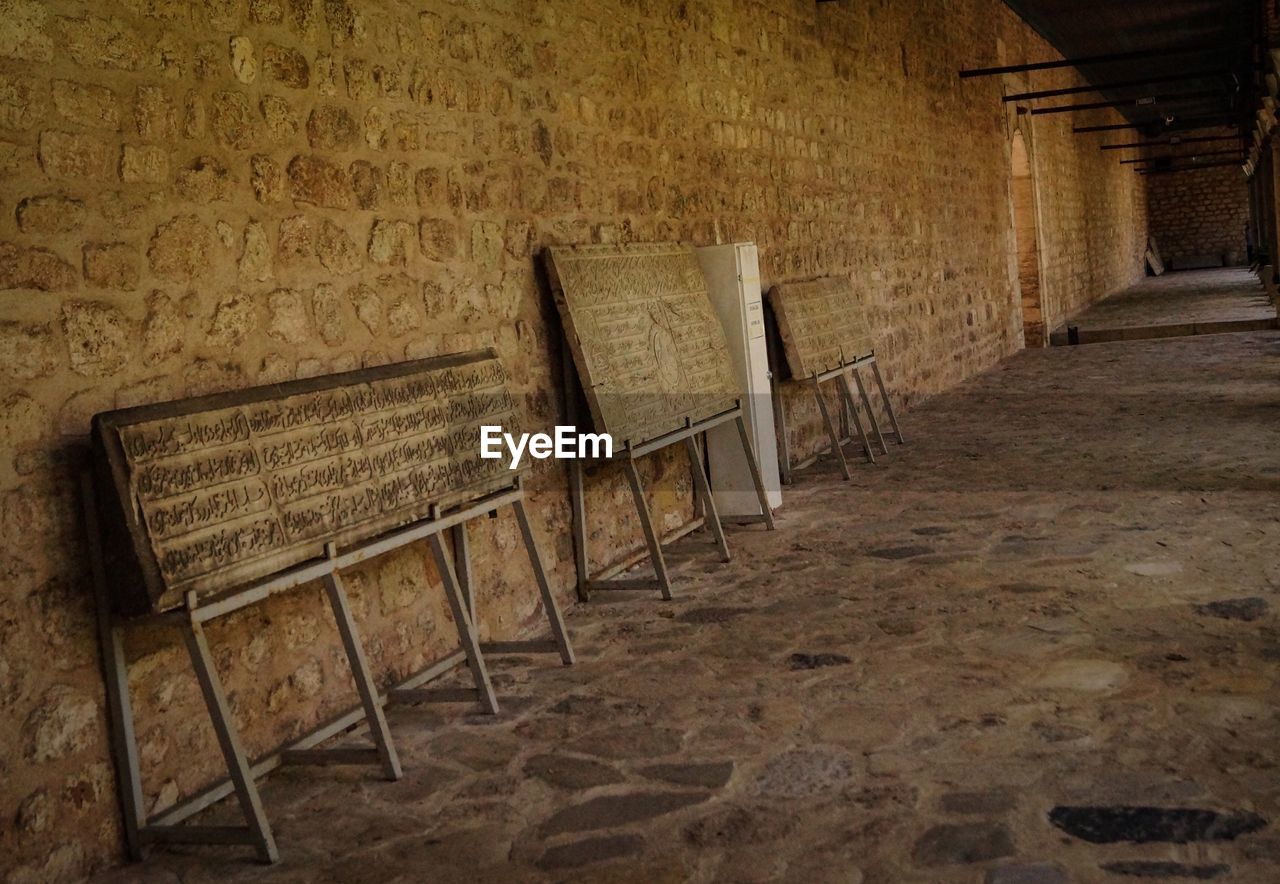 EMPTY CHAIRS AND TABLE IN OLD BUILDING