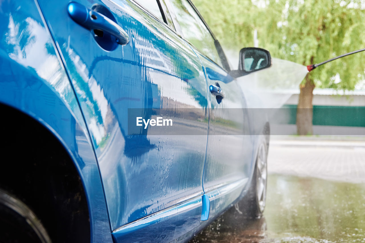 Car washing. cleaning car with contactless high pressure washing. self wash station