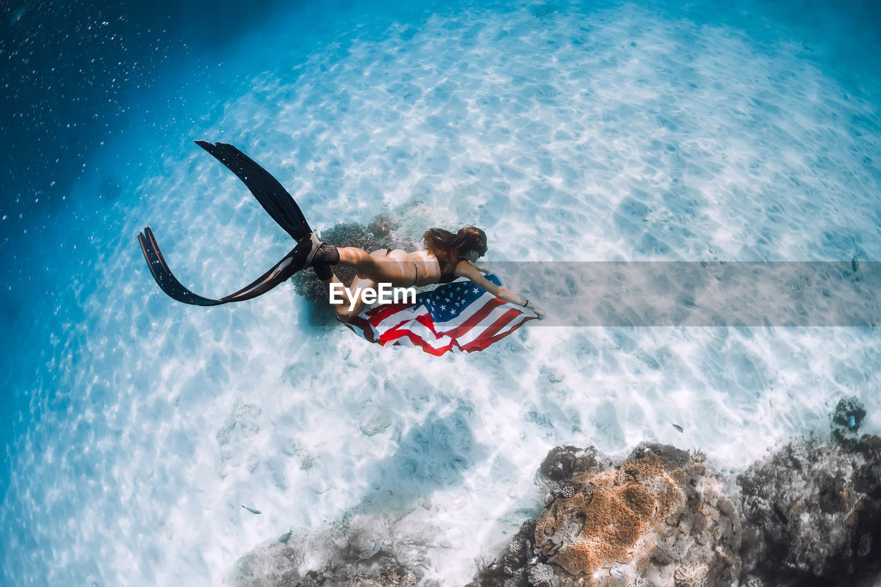 rear view of man swimming in sea