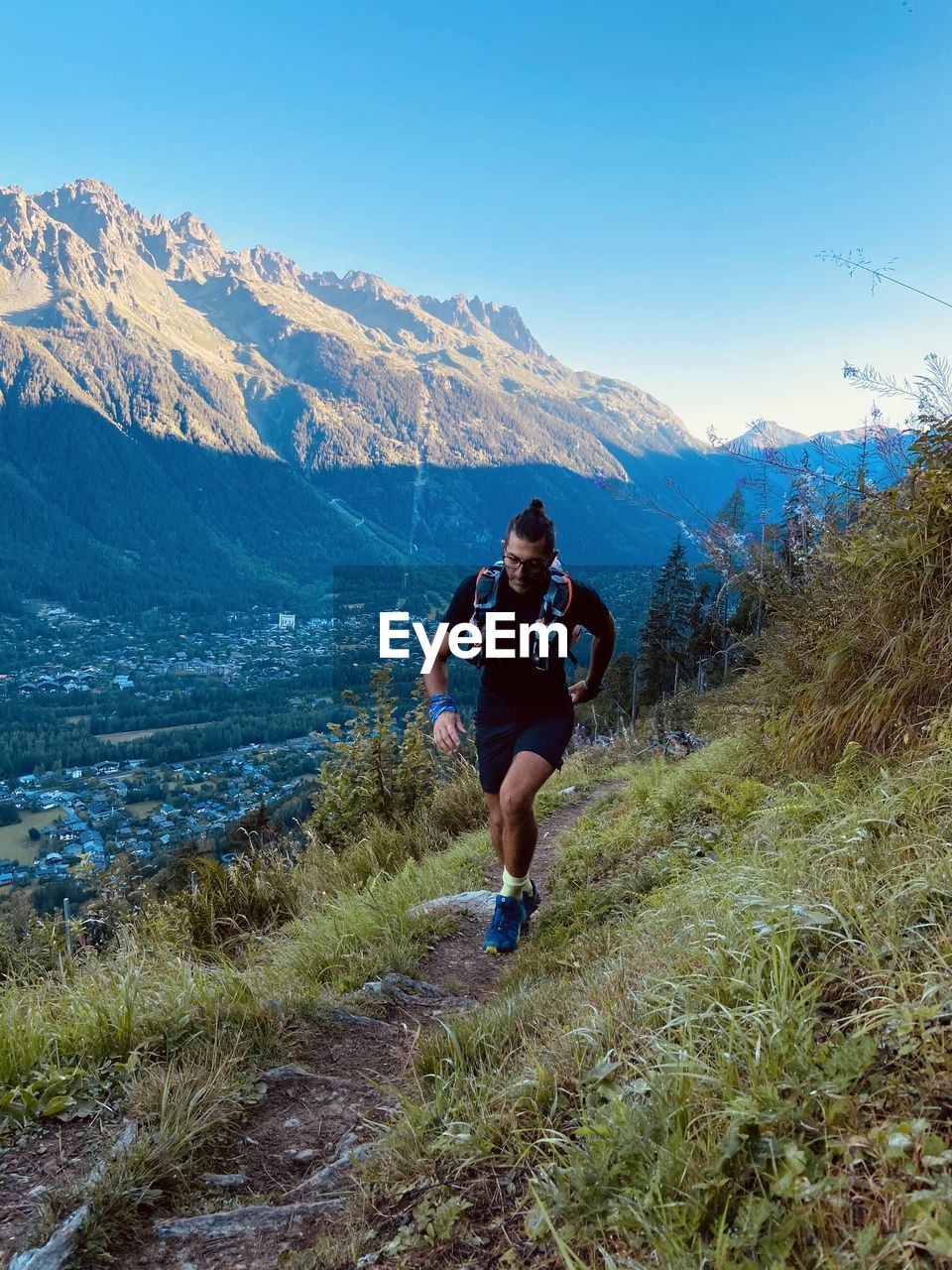 Full length of man running on mountain against sky