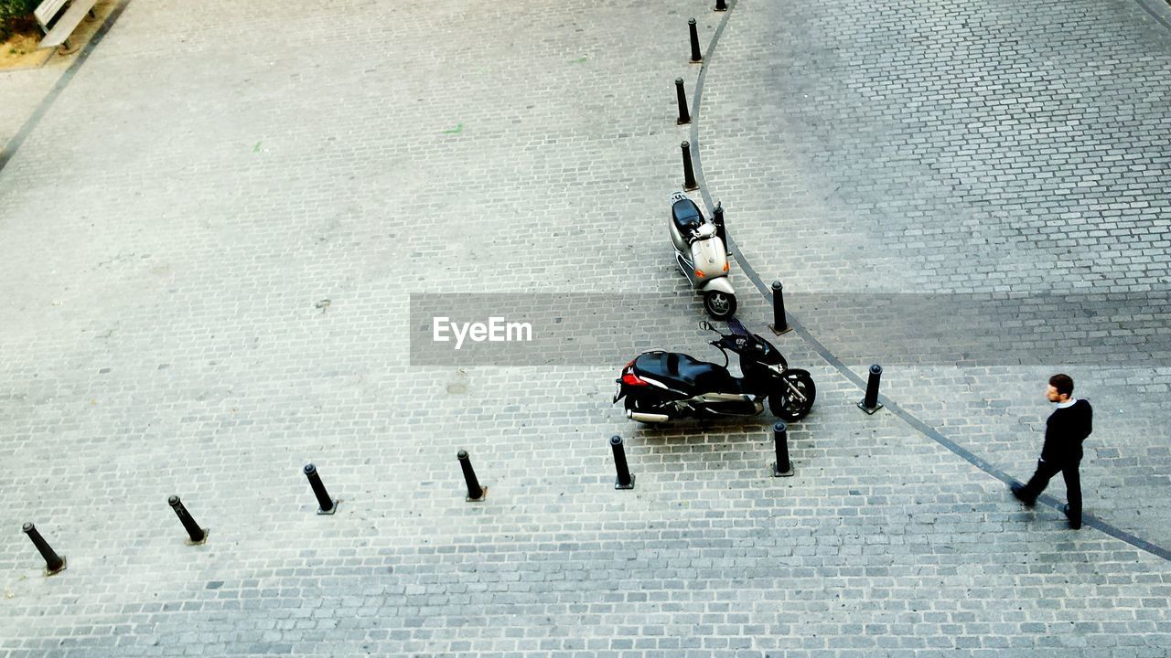 High angle view of man walking on sidewalk