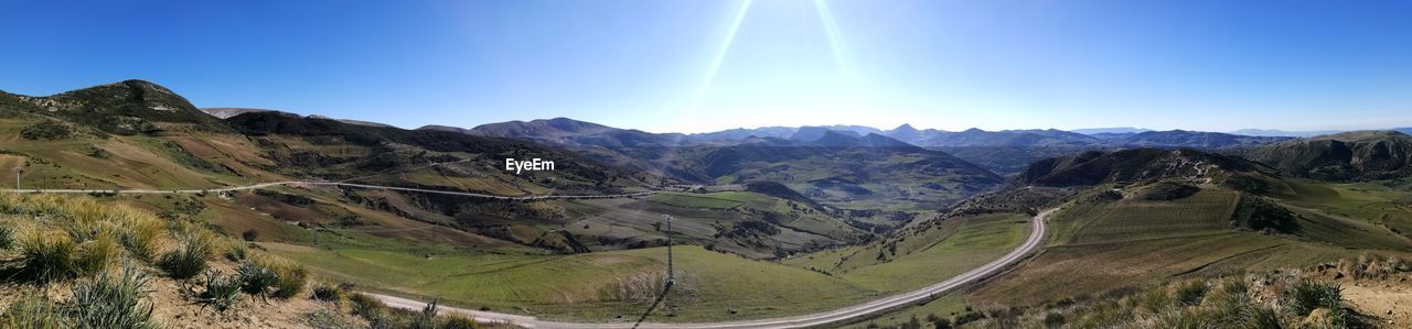 Bratuful landscape of the countryside of guelma, algeria with cloudy sky and green trees and grass