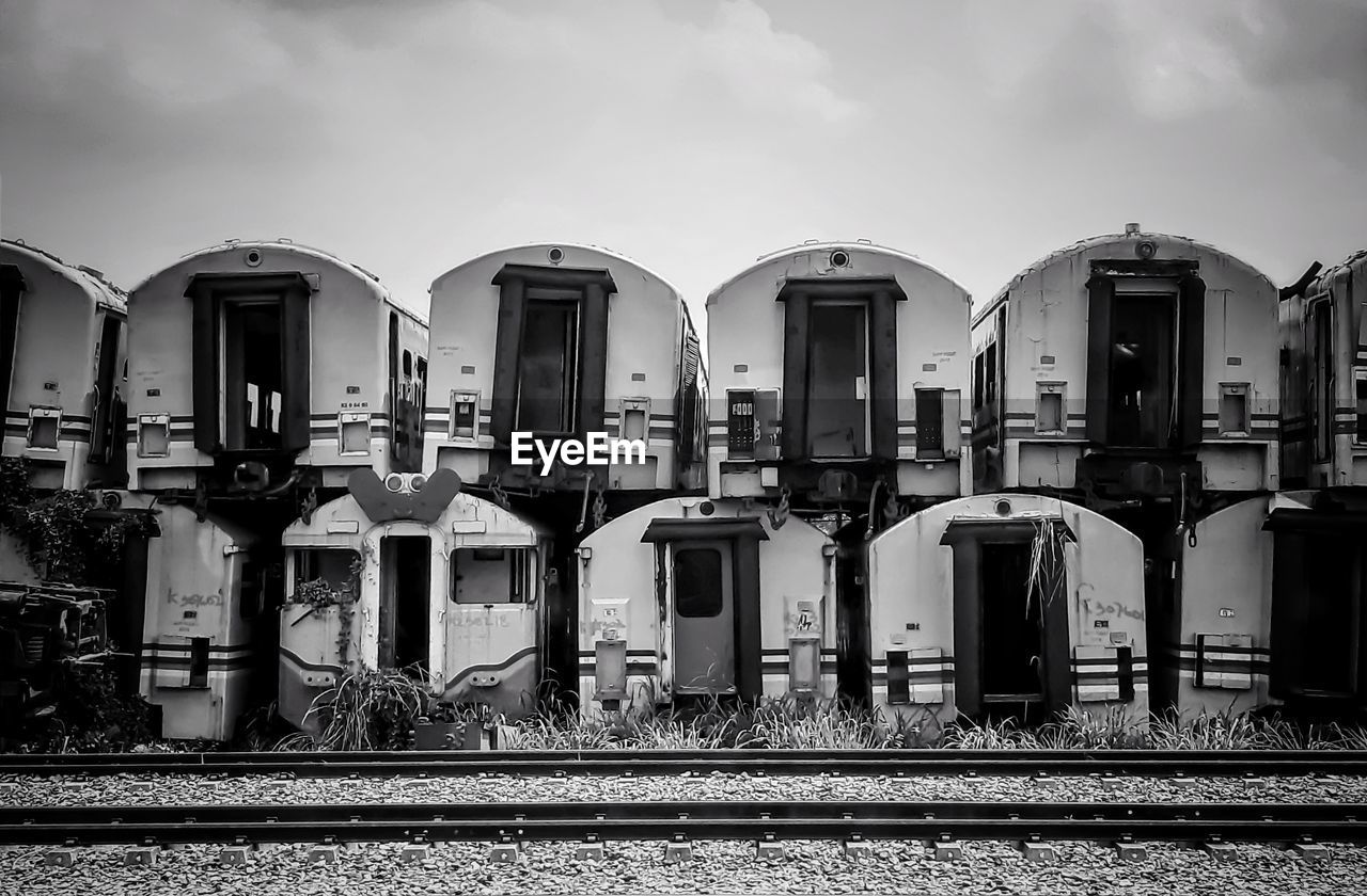 Railroad tracks by buildings against sky