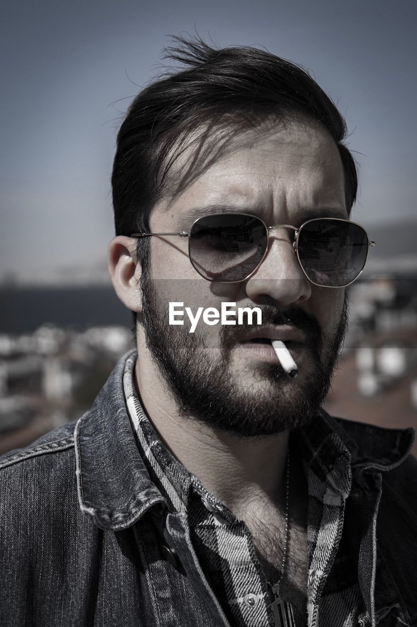 PORTRAIT OF YOUNG MAN WITH CIGARETTE