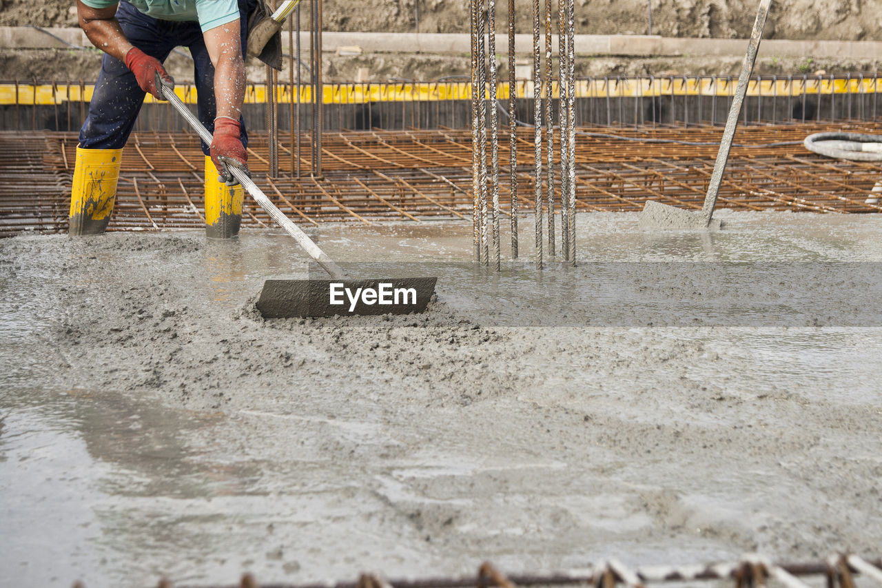 Low section of man working at construction site