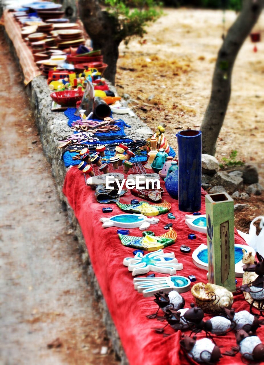 Handicrafts arranged on retaining wall outdoors