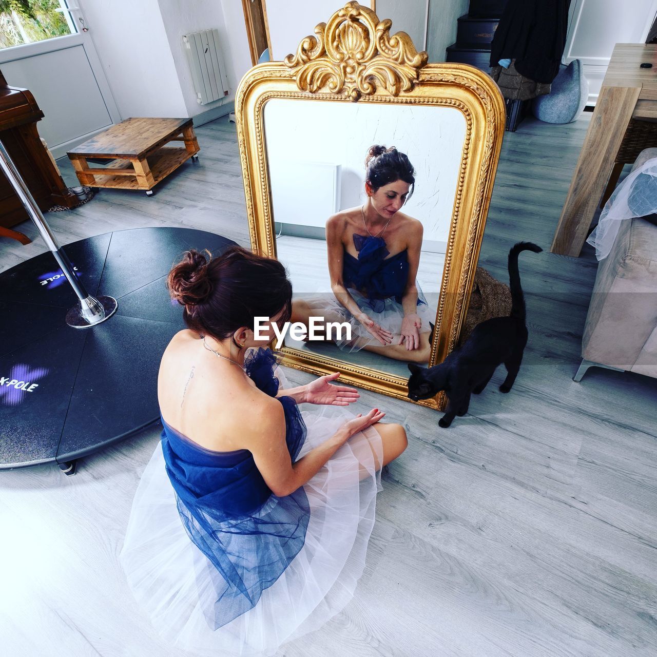 Rear view of woman sitting on sofa at home