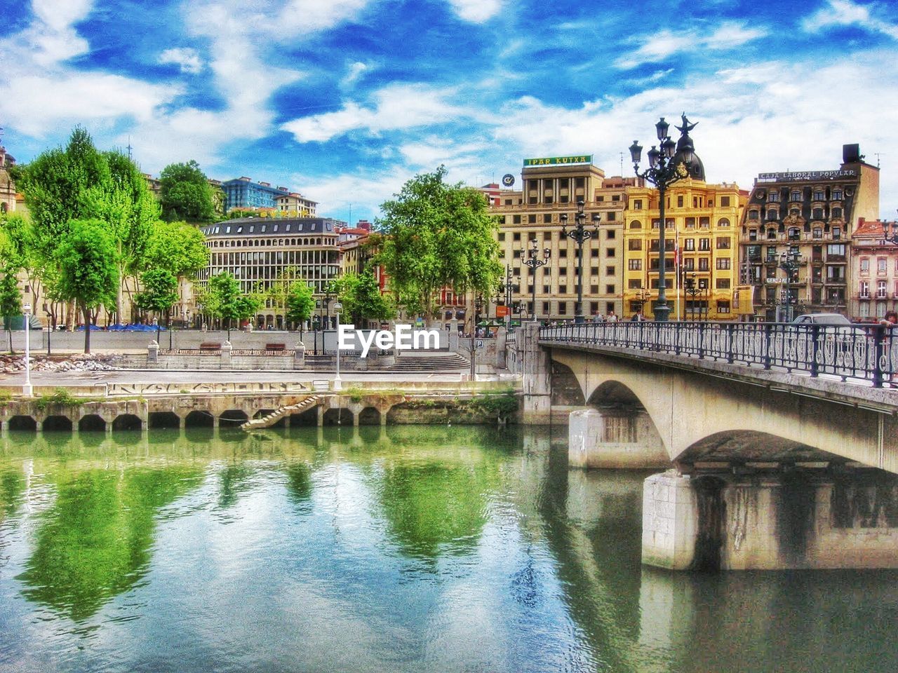 VIEW OF RIVER WITH BUILDINGS IN BACKGROUND