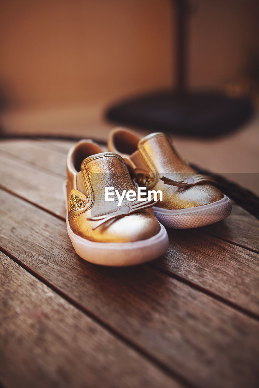 close-up, footwear, wood, yellow, shoe, brown, pair, no people, indoors, selective focus, still life, table, white, two objects