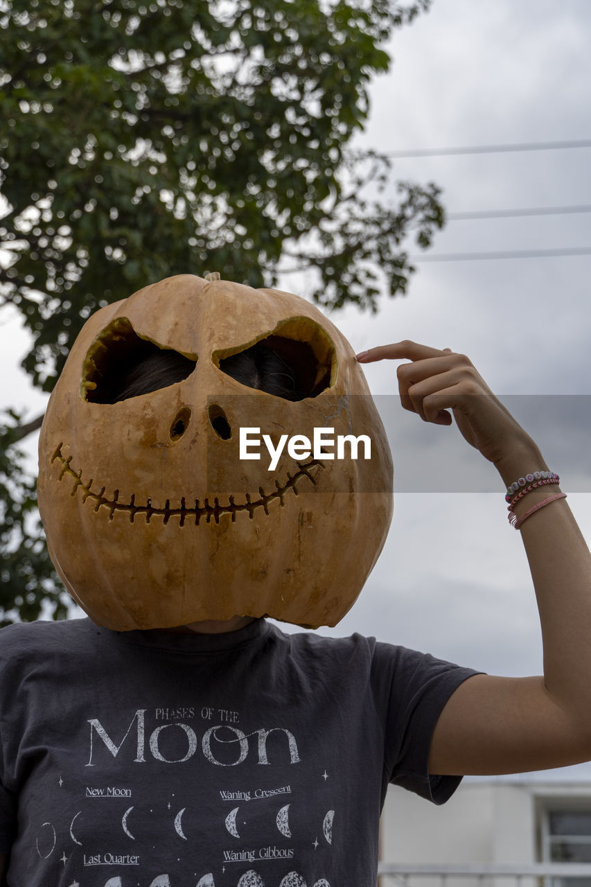 cropped hand of man with face paint