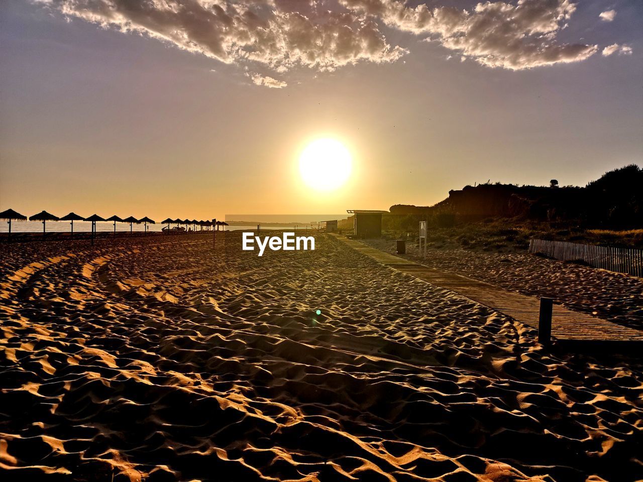 SCENIC VIEW OF SUNSET OVER BEACH