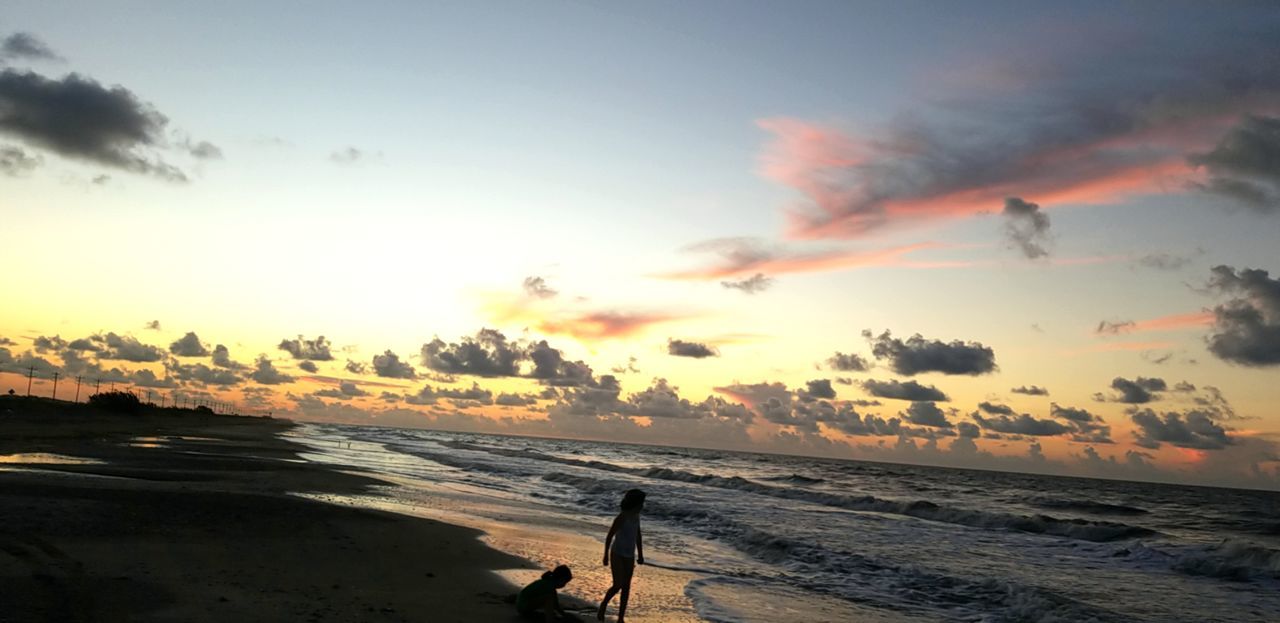 SCENIC VIEW OF BEACH DURING SUNSET