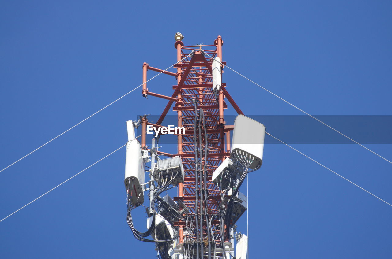 technology, sky, blue, clear sky, electricity, communication, communications tower, architecture, global communications, nature, vehicle, wireless technology, low angle view, industry, built structure, mast, telecommunications engineering, tower, sunny, broadcasting, day, no people, outdoors, antenna, telecommunications equipment, power generation, overhead power line, satellite dish, cable, satellite, equipment, metal, business, business finance and industry, copy space