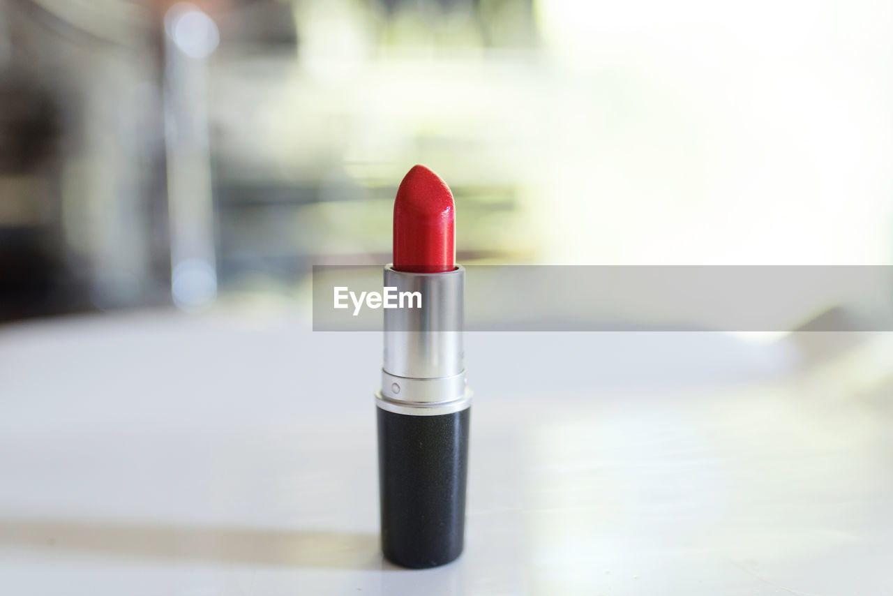 Close-up of red lipstick on table