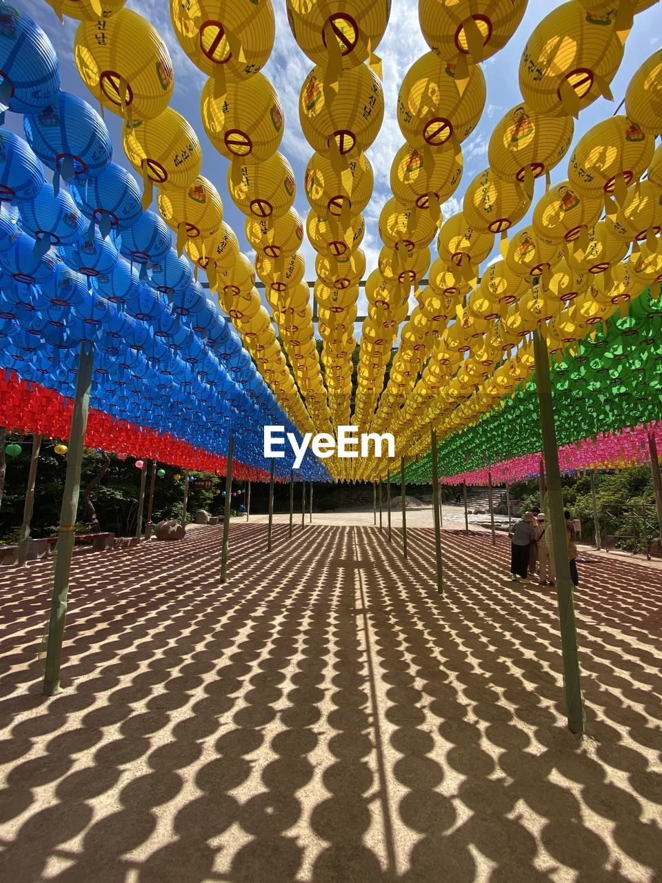 MULTI COLORED UMBRELLAS ON TILED FLOOR AGAINST WALL