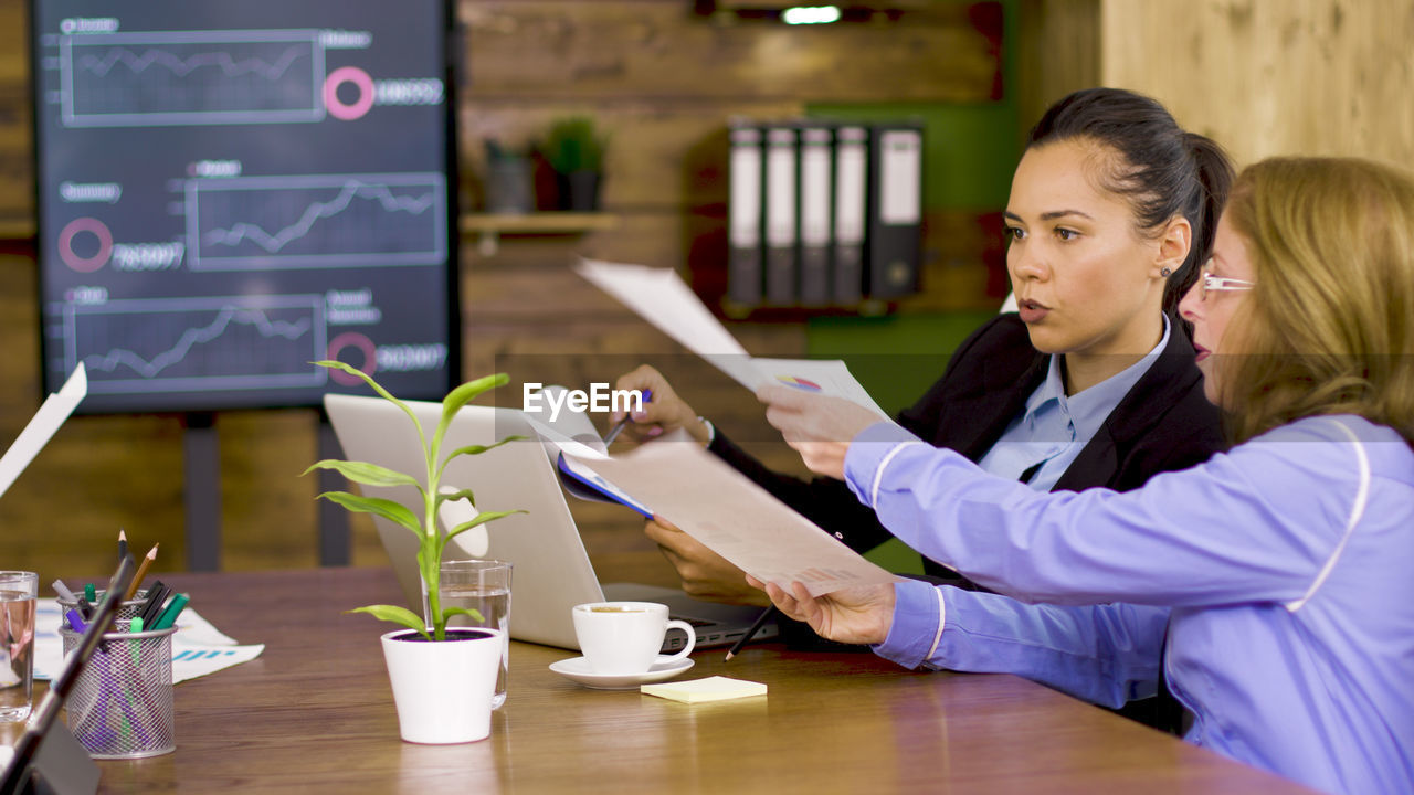 businesswoman working at table in office